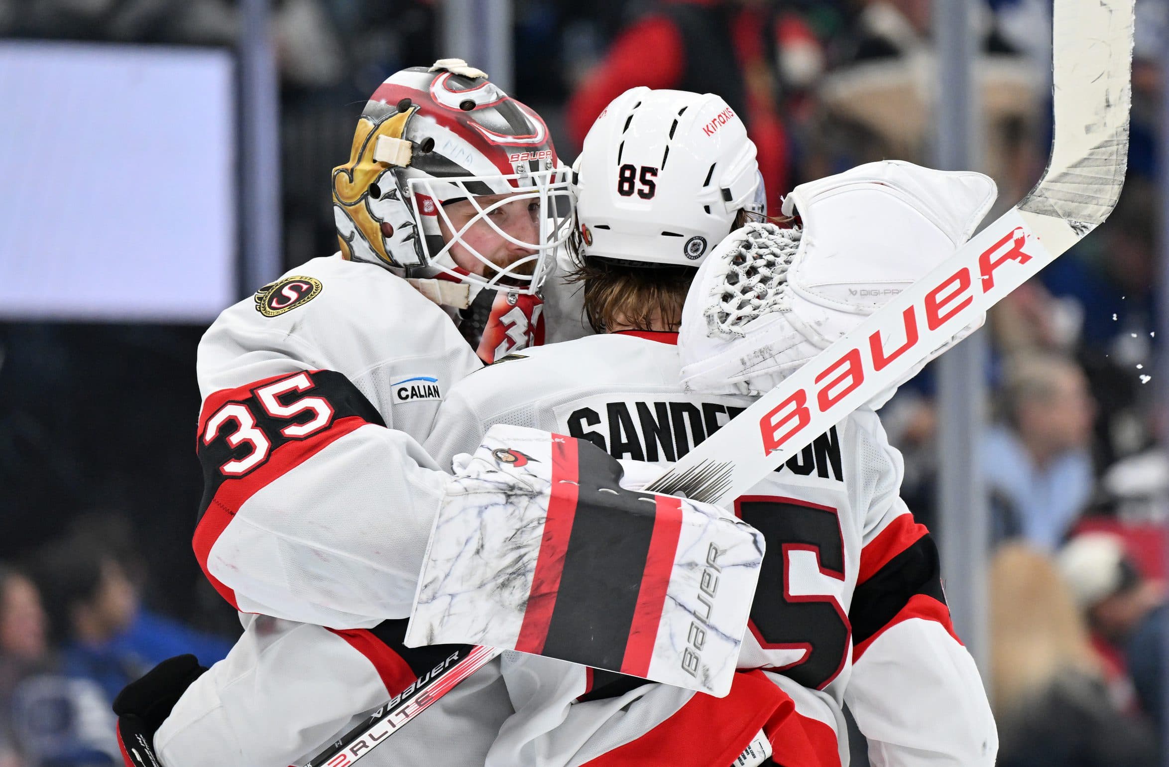 Ottawa Senators goalie Linus Ullmark (35) embraces defenseman Jake Sanderson (85) as they celebrate a win over the Toronto Maple Leafs at Scotiabank Arena.